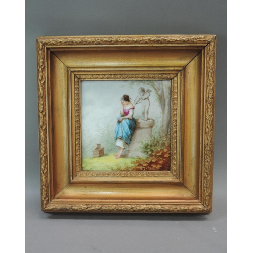 58 - A continental square panel painted with a young woman standing before a pillar with cupid and his bo... 