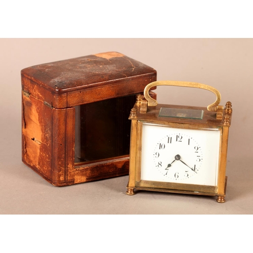 6 - A brass case carriage clock, with swing handle, plain case, white enamel dial with Arabic numerals, ... 