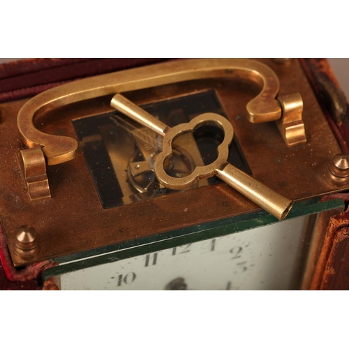 6 - A brass case carriage clock, with swing handle, plain case, white enamel dial with Arabic numerals, ... 