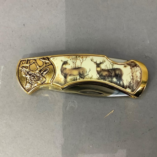 17 - A ten point buck collector knife by Franklin Mint, stainless steel blade, gilt metal frame cast with... 