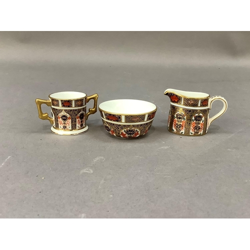 29 - A Royal Crown Derby miniature sugar bowl and cream jug and a two handled loving cup all in pattern 1... 