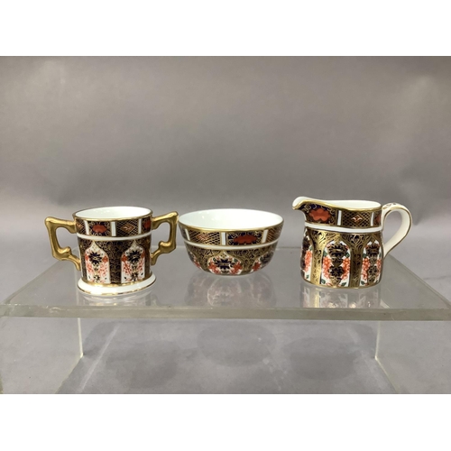 29 - A Royal Crown Derby miniature sugar bowl and cream jug and a two handled loving cup all in pattern 1... 