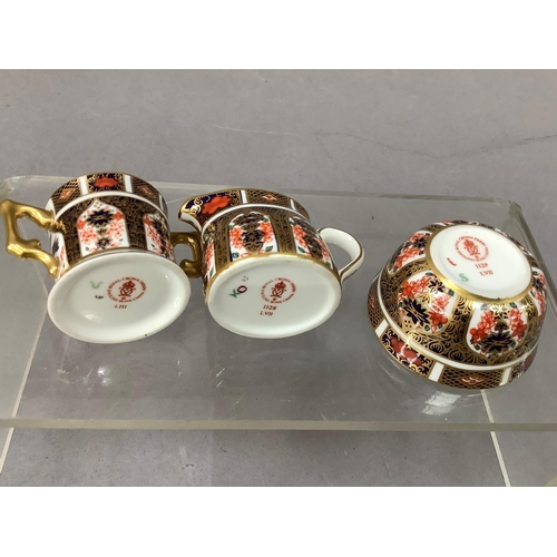 29 - A Royal Crown Derby miniature sugar bowl and cream jug and a two handled loving cup all in pattern 1... 