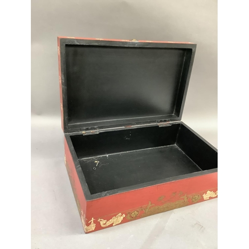 4 - A chinoiserie storage box of red ground printed with figures in a garden landscape, 41cm wide by 26c... 