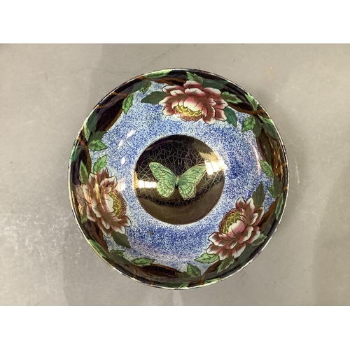 50 - A Maling ware fruit bowl of orange and blue lustre printed with a border of peony and a butterfly to... 