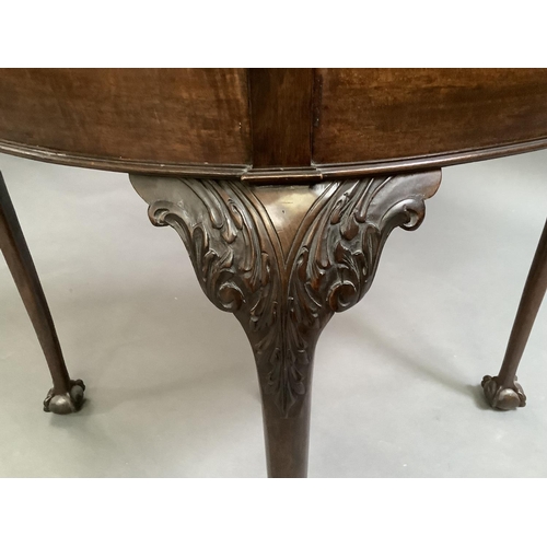 725 - A mahogany card table in George III style, the D-shaped top above a deep frieze on acanthus carved c... 