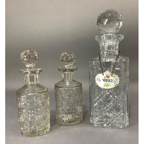 17 - A hobnail cut spirit decanter with facetted stopper and china whisky label together with two cylindr... 