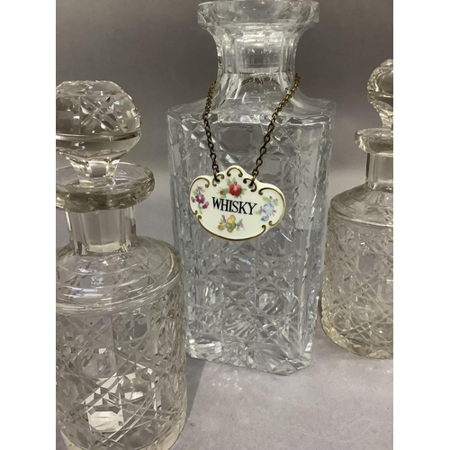 17 - A hobnail cut spirit decanter with facetted stopper and china whisky label together with two cylindr... 