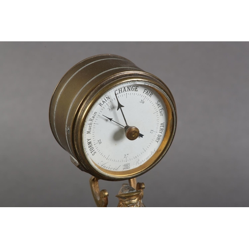 8 - A late 19th century gilt-brass desk barometer, the drum casing held aloft by the figure of a China m... 