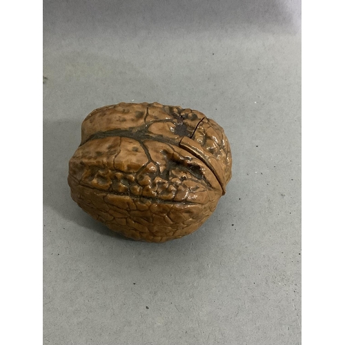 24 - A bijouterie walnut shell converted to a small container with hinged lid, approximately 4.5cm wide