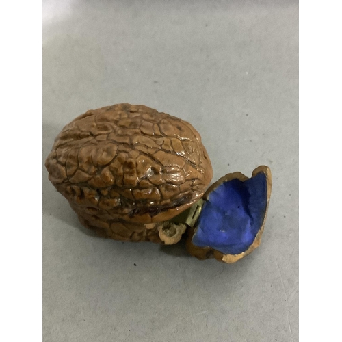 24 - A bijouterie walnut shell converted to a small container with hinged lid, approximately 4.5cm wide