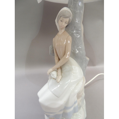 28 - A Nao lamp modelled as a country girl with sheep, 45cm to fittings approximately