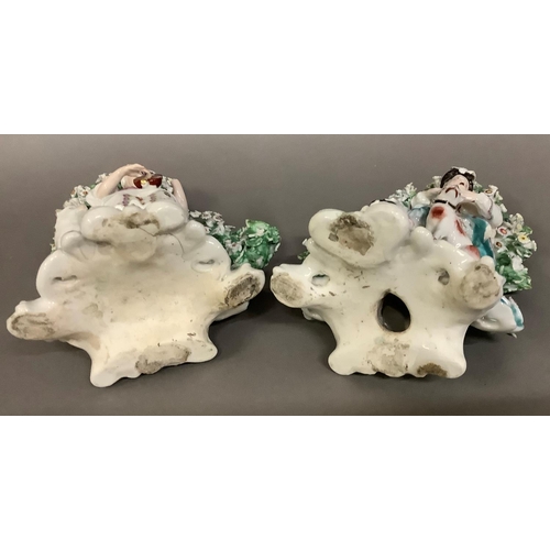 33 - A pair of Derby porcelain seated bocage figures of a piper and hound and shepherdess with lamb, appr... 