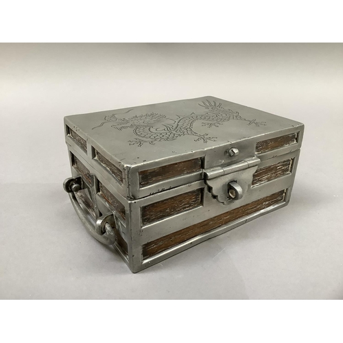 2 - A Chinese hardwood and pewter casket, c.1930s, modelled as a strong box, the cover incised with a si... 