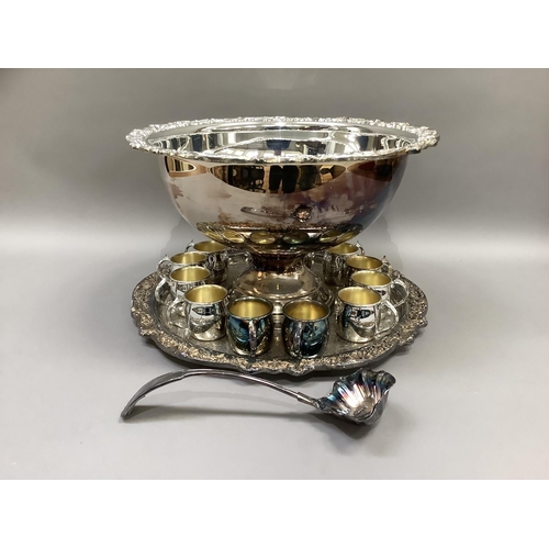 3 - A silver plated punch bowl and stand having a shell and grapevine cast border, a set of twelve punch... 