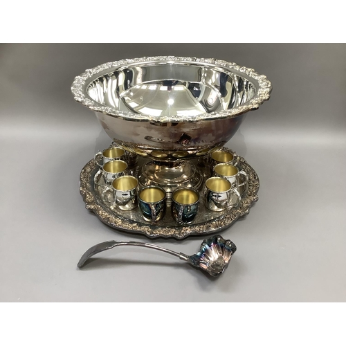 3 - A silver plated punch bowl and stand having a shell and grapevine cast border, a set of twelve punch... 