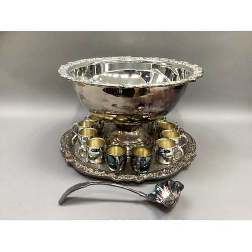 3 - A silver plated punch bowl and stand having a shell and grapevine cast border, a set of twelve punch... 