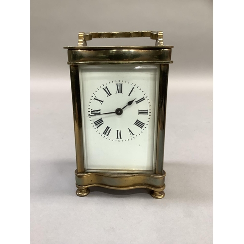 4 - An early 20th century French brass carriage clock, the white dial with Roman numerals, 15cm high ove... 