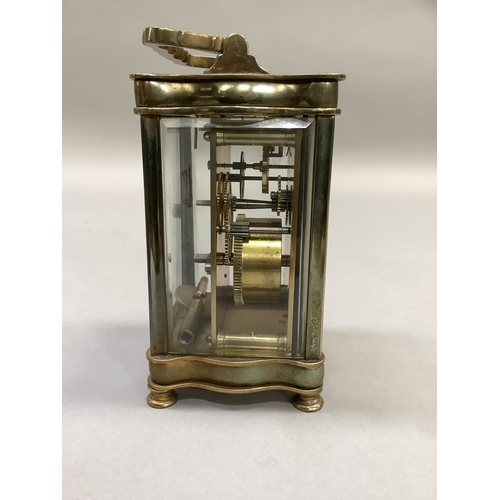 4 - An early 20th century French brass carriage clock, the white dial with Roman numerals, 15cm high ove... 