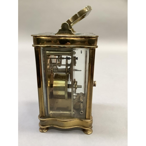 4 - An early 20th century French brass carriage clock, the white dial with Roman numerals, 15cm high ove... 