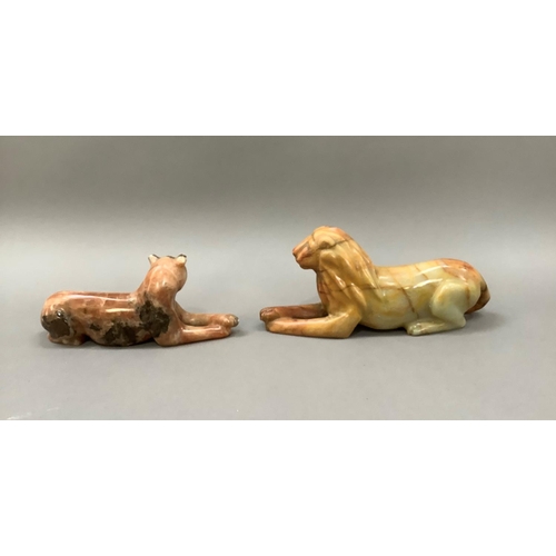 5 - A carved onyx lion and lioness each resting on a plinth of onyx, 11cm and 10cm high, plinths 24.5cm ... 