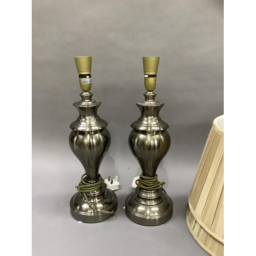 184 - A pair of pewter coloured table lamps of baluster form on circular bases complete with shades, 46cm ... 