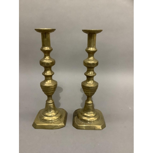 186 - Pair of Victorian brass candlesticks, baluster columns on domed and square canted bases, 34cm high