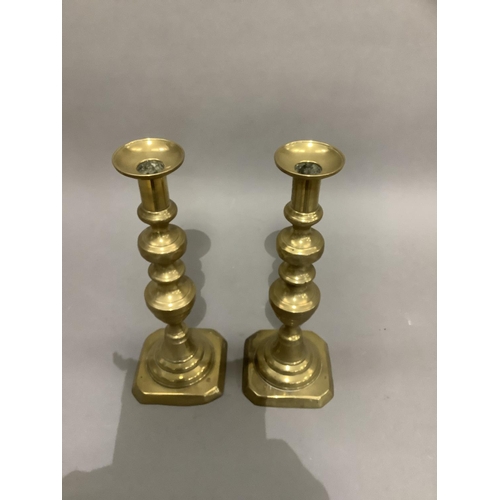 186 - Pair of Victorian brass candlesticks, baluster columns on domed and square canted bases, 34cm high