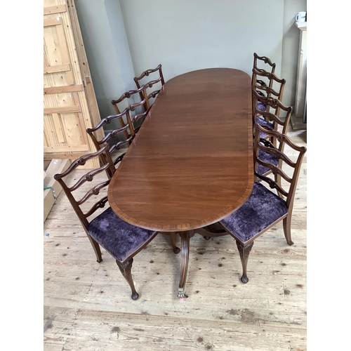 365 - A mahogany and rosewood cross banded twin pedestal dining table on down swept moulded legs with bras... 