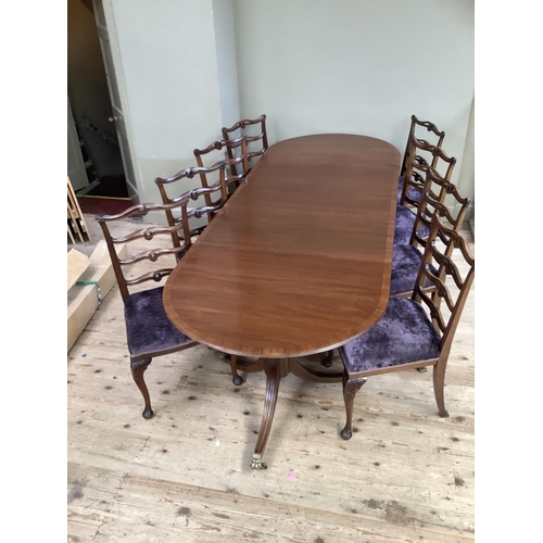 365 - A mahogany and rosewood cross banded twin pedestal dining table on down swept moulded legs with bras... 