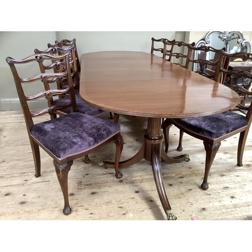 365 - A mahogany and rosewood cross banded twin pedestal dining table on down swept moulded legs with bras... 