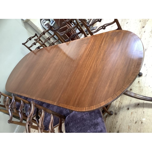 365 - A mahogany and rosewood cross banded twin pedestal dining table on down swept moulded legs with bras... 