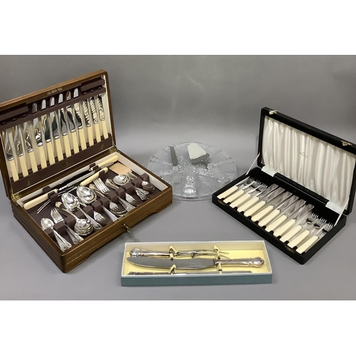 185 - A walnut canteen of silver plated cutlery for six, a boxed three piece carving set to match the cant... 