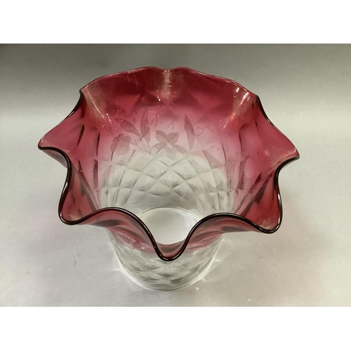 31 - A Victorian cranberry tinted and etched light shade with folded rim and diamond quilted moulded body... 