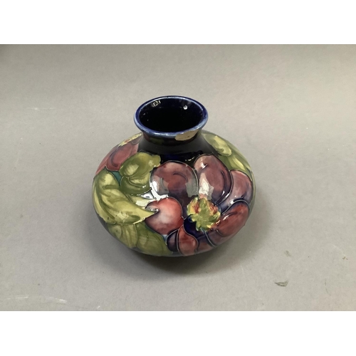 32 - A Moorcroft 'clematis' vase of compressed circular form painted and tube lined in shades of mauve, p... 