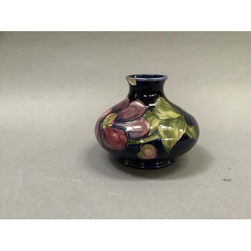 32 - A Moorcroft 'clematis' vase of compressed circular form painted and tube lined in shades of mauve, p... 