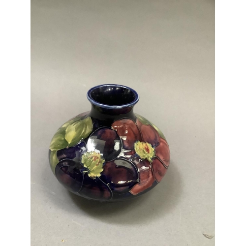 32 - A Moorcroft 'clematis' vase of compressed circular form painted and tube lined in shades of mauve, p... 