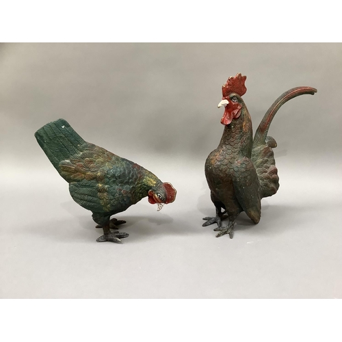 1 - A cold painted metal cockerel and hen, 29cm high