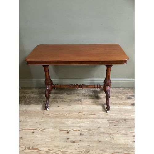 361 - A Victorian mahogany window table, rectangular on leaf carved refectory standards joined by conformi... 