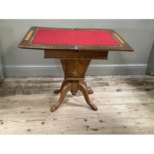 196 - A Victorian walnut and Tunbrigeware banded combined games and work table inlaid to the fold over top... 