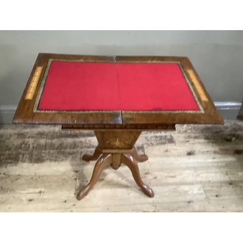 196 - A Victorian walnut and Tunbrigeware banded combined games and work table inlaid to the fold over top... 