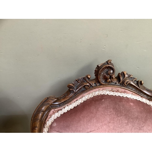 166 - A pair of 19th century mahogany salon chairs with rocaille cresting, pink velvet upholstered back an... 