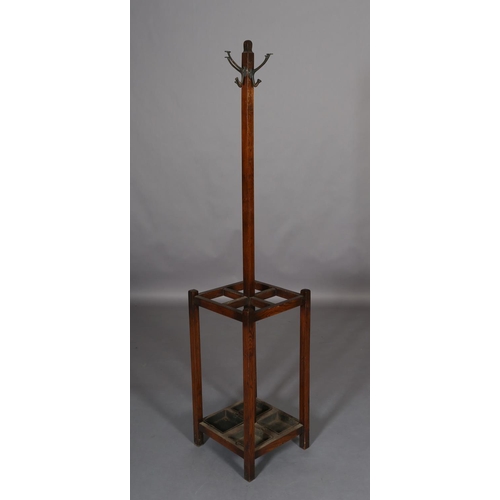 133 - An oak hall stand c.1930s, with four hat and coat pegs, the square section base with drip trays for,... 