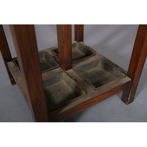 133 - An oak hall stand c.1930s, with four hat and coat pegs, the square section base with drip trays for,... 