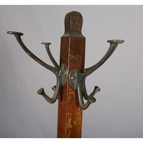 133 - An oak hall stand c.1930s, with four hat and coat pegs, the square section base with drip trays for,... 