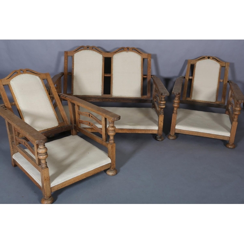 153 - An oak framed suite c.1920s, the two seater sofa having a double arched and pierced back, the arm pa... 