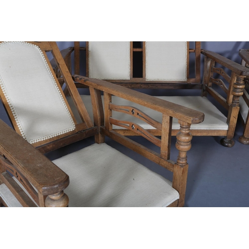 153 - An oak framed suite c.1920s, the two seater sofa having a double arched and pierced back, the arm pa... 