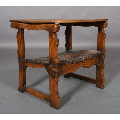 156 - An oak monk's chair c.1920s having a fold down foliate carved panel back, hide seat, on square mould... 