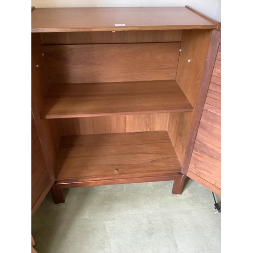 158 - A 1970s teak two door louvred cupboard on short legs