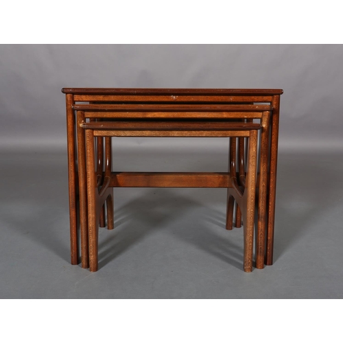 300 - A nest of three teak coffee tables, rectangular on curved 'H' standards, 57cm wide x 40cm deep x 48c... 